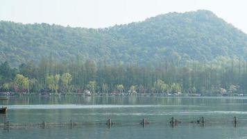 The beautiful lake landscapes in the Hangzhou city of the China in spring with the peaceful lake and fresh green mountains photo