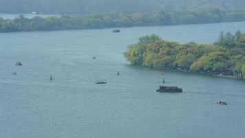 The beautiful lake landscapes in the Hangzhou city of the China in spring with the peaceful lake and fresh green mountains photo