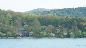 The beautiful lake landscapes in the Hangzhou city of the China in spring with the peaceful lake and fresh green mountains photo