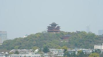 The beautiful lake landscapes in the Hangzhou city of the China in spring with the peaceful lake and fresh green mountains photo