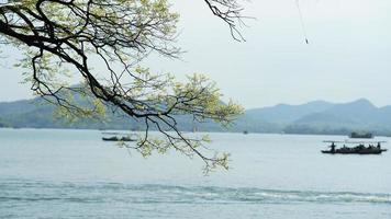 The beautiful lake landscapes in the Hangzhou city of the China in spring with the peaceful lake and fresh green mountains photo