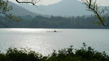 The beautiful lake landscapes in the Hangzhou city of the China in spring with the peaceful lake and fresh green mountains photo