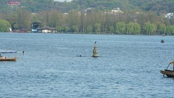 The beautiful lake landscapes in the Hangzhou city of the China in spring with the peaceful lake and fresh green mountains photo