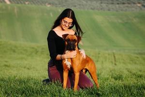 Beautiful woman playing with her dog. Outdoor portrait. photo