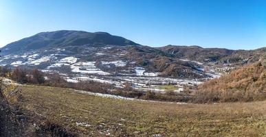 Wide angle winter panorama of the hilly area of Oltrepo Pavese, Northern Italy, Lombardy Region, covered by snow. photo