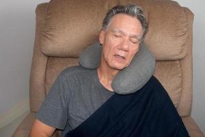 Mature Man Taking a Nap in the Middle of the Day in an Easy Chair photo