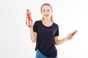 Young pretty woman portrait hold stack of gift boxes. Smiling happy girl in t-shirt on white background. Holiday, summer,discounts concept. Copy space, blank, mock up. photo