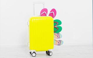 suitcase isolated on white background Summer holidays. summer flip flops or slippers.Sandals beach.Red cap.Travel valise or bag. Mock up. Copy space. Template. Blank. photo