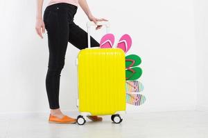 girl with suitcase isolated on white background .Summer holidays. summer flip flops or slippers. Travel valise or bag. Mock up. Copy space. Template. Blank. photo