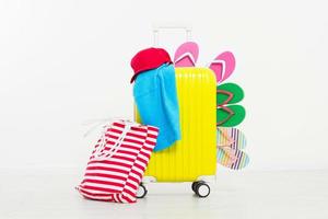 suitcase isolated on white background Summer holidays. summer flip flops or slippers.Sandals beach.Red cap.Travel valise or bag. Mock up. Copy space. Template. Blank. photo