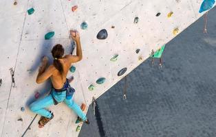 A man is climbing a climbing wall photo