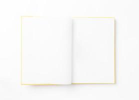 Open empty photo album on white background. Top view