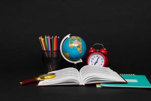 colorful collection of school supplies set on black background. back to school. great ideas photo