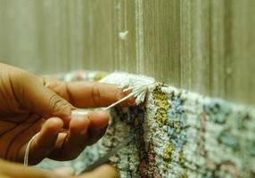 weaving and manufacturing of handmade carpets closeup photo