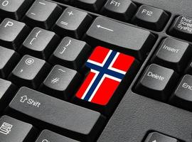 un teclado negro con una tecla en los colores de la bandera de Noruega foto