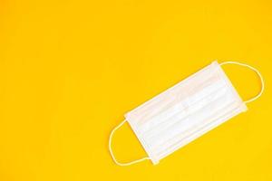 Medical mask on yellow background. Procedure mask from bacteria. Protection concept photo