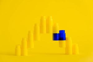 Yellow plastic building blocks in shape of a pyramid on yellow background. Background of plastic details building blocks photo