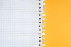 Blank notebook for writing on yellow background photo