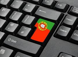 A Black Keyboard With Portugese Flag Key photo