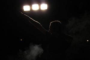 The Champion - Silhouette of a happy man celebrating his victory. Fog floating around him. photo