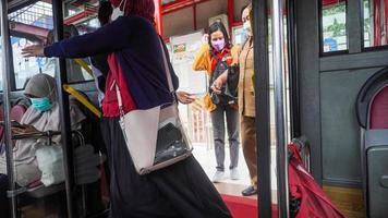 Semarang, Central Java, Indonesia, 2021 - Passengers enter the public transportation, the bus rapid transit system photo