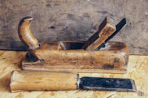 Old construction tools on a wooden workbench flat lay background. Carpenter table photo