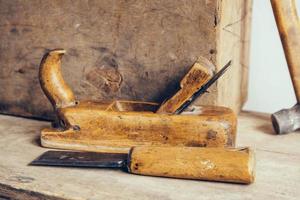 Old construction tools on a wooden workbench flat lay background. Carpenter table. Woodwork photo