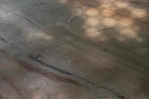 The shadow of the light that shines to marble table in the garden. photo