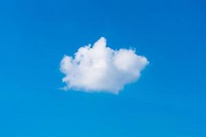 Single white cloud on blue sky background at daytime photo