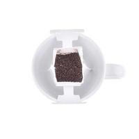 Drip bag coffee hanging on a coffee cup isolated on white background. photo