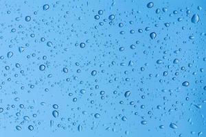 Natural water drops on window glass background photo