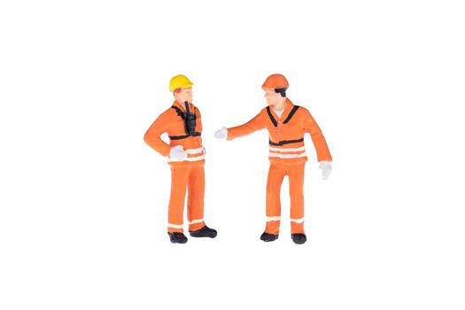 Close up of Miniature people in engineer and worker occupation isolate on white background. Elegant Design with copy space for placement your text, mock up for industrial and construction concept photo