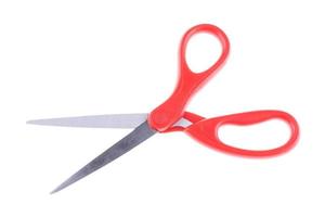 Closeup of one red scissors isolated on a white background. Stationary equipment concept photo