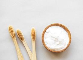 Bamboo toothbrushes on white background photo