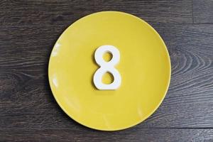 Figure eight on a yellow plate. photo