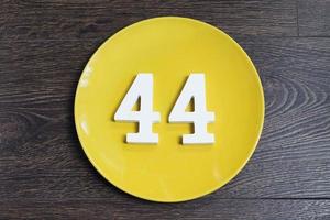 Number forty four on the yellow plate. photo