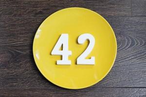 Number forty two on the yellow plate. photo