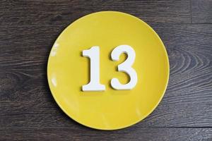 The number thirteen on the yellow plate. photo