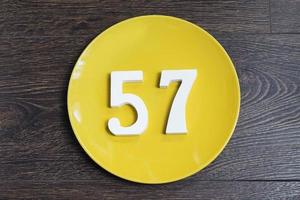 The number fifty-seven on the yellow plate. photo