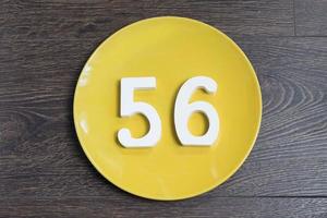 The number fifty-six on the yellow plate. photo