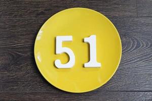 The number fifty-one on the yellow plate. photo