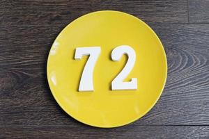 The number seventy-two on the yellow plate. photo