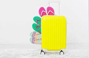 suitcase isolated on white background Summer holidays. summer flip flops or slippers.Sandals beach.Red cap.Travel valise or bag. Mock up. Copy space. Template. Blank. photo