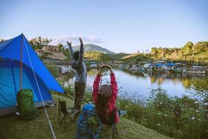 Asian couple Mountain camps in rural villages, close to the lake, travel ideas, camping, relaxing holidays.in Thailand photo