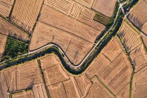 Agricultural barren fields with irrigation canal in farmland at countryside