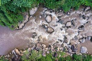 Natural rapids flowing through lush forest in national park photo