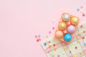 Flat lay top view colorful easter egg painted in pastel colors composition on pink pastel color background. Easter day background top view with copy space. photo