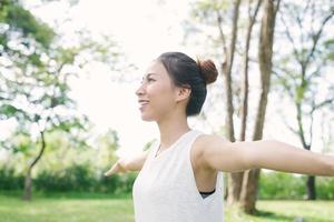 Young asian woman yoga outdoors keep calm and meditates while practicing yoga to explore the inner peace. Yoga and meditation have good benefits for health. Yoga Sport and Healthy lifestyle concept. photo