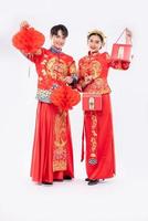 Men and women wearing cheongsam Standing holding red bag and honeycomb lantern photo