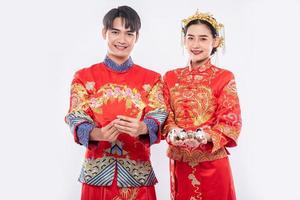 Chinese new year, men and women wear Cheongsam smile to get - give the gift money and cash to relative photo